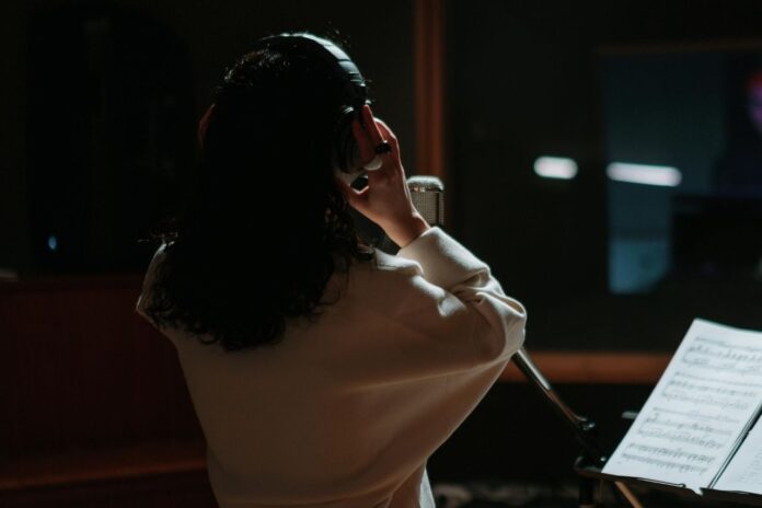 Indie artist recording music in a studio, representing Jamendo Music and independent creativity