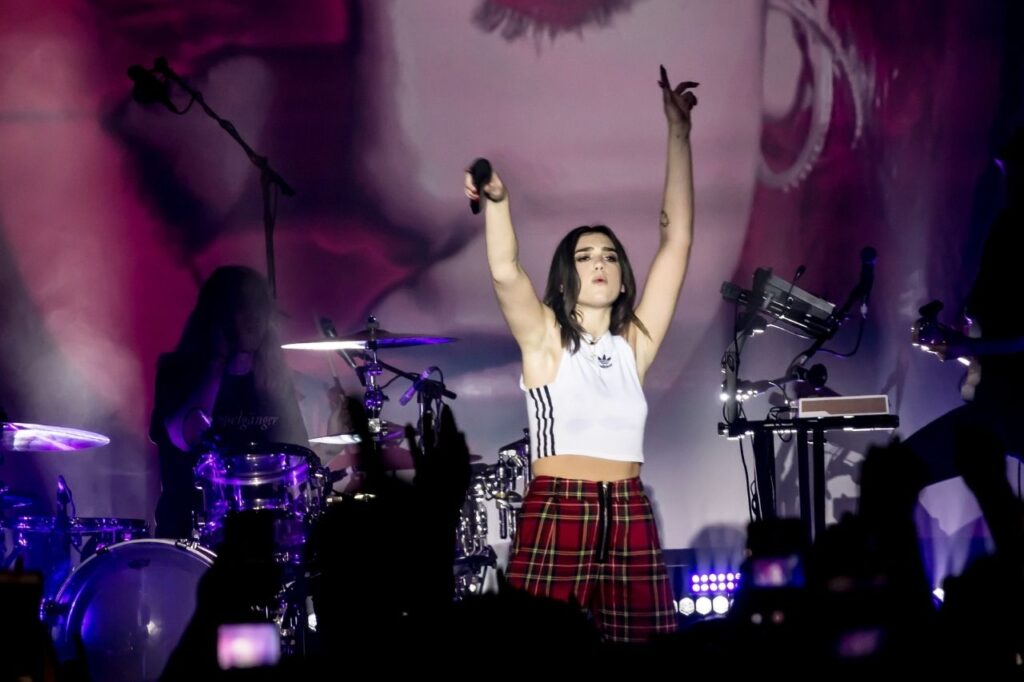 Dua Lipa performing live at The Palladium in Hollywood during her 2018 self-titled tour, a defining moment highlighted in the Dua Lipa Biography.