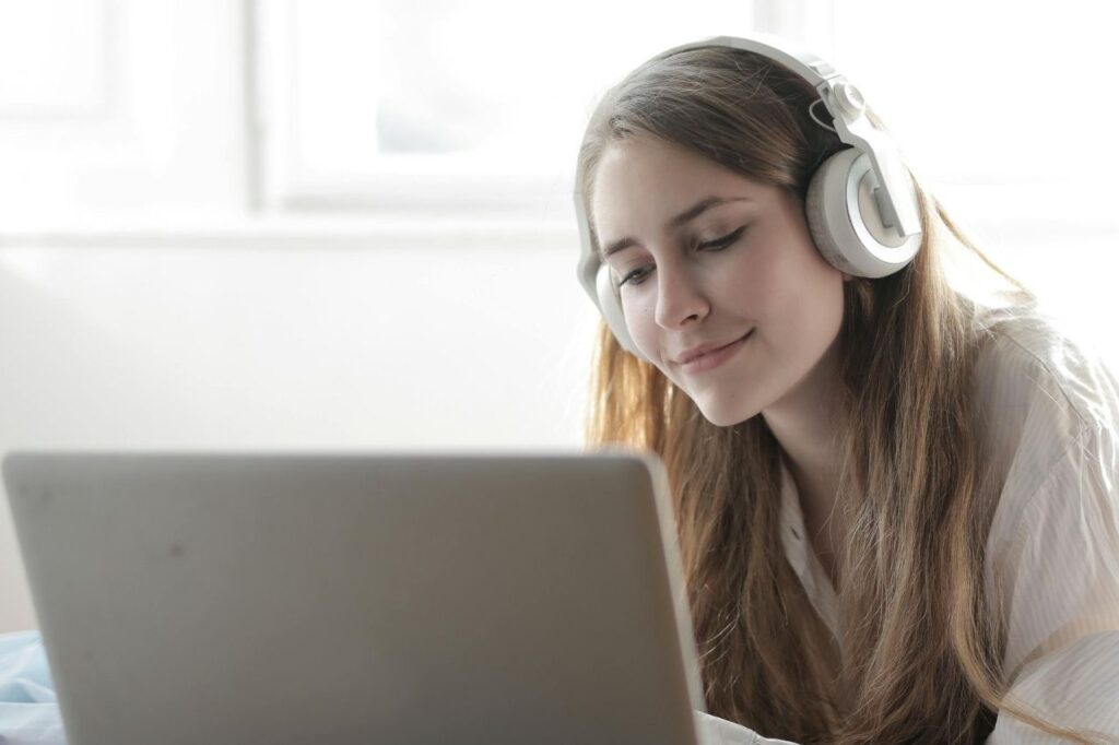 Person enjoying music online on one of the best video song streaming sites.