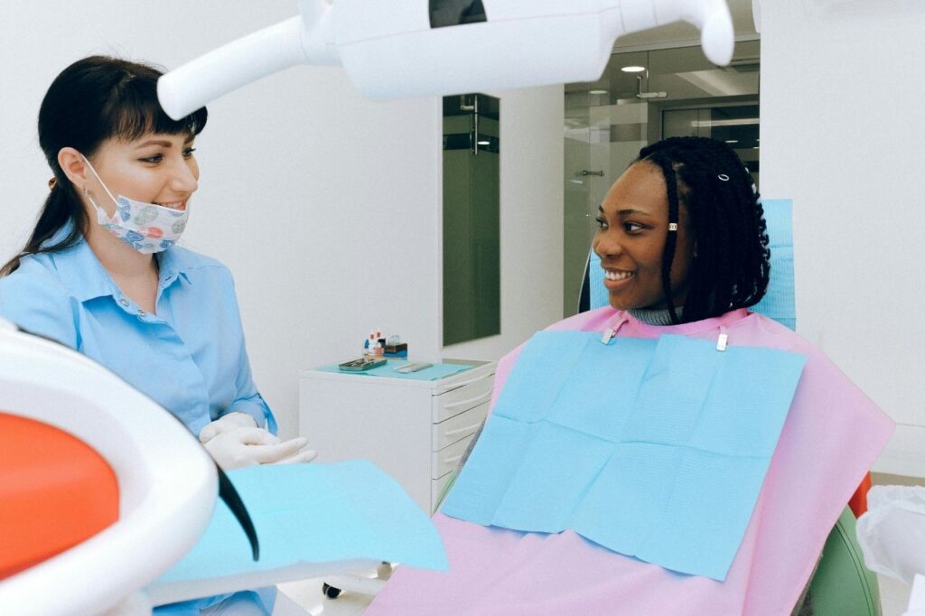 A patient speaking with a dentist during a consultation for perfect smile veneers.