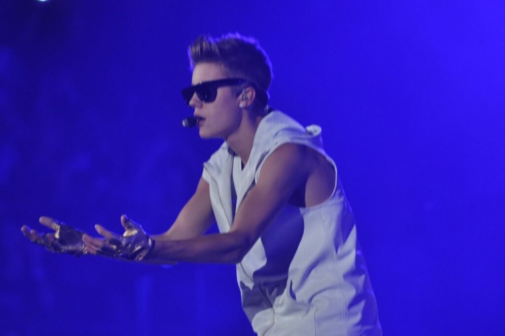 Justin Bieber performing live on stage during the Believe Tour while promoting the Believe Deluxe Edition album.